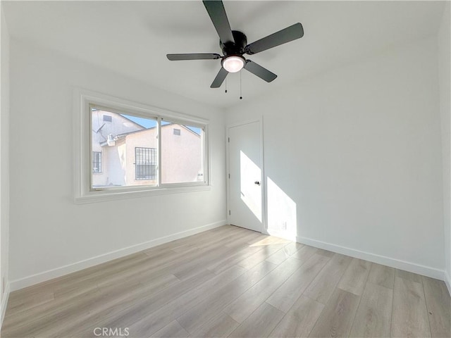 unfurnished room featuring light wood-type flooring and ceiling fan