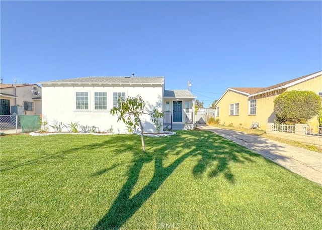 rear view of house featuring a lawn