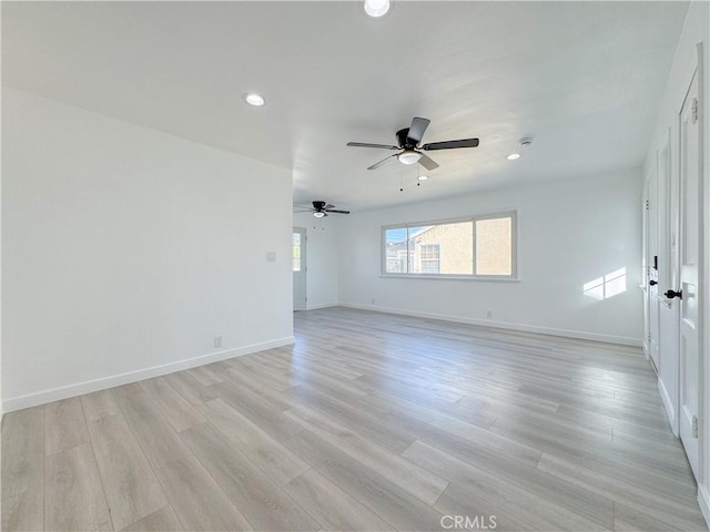 unfurnished room featuring ceiling fan and light wood-type flooring