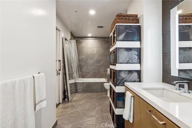 full bathroom featuring vanity, shower / tub combo, and toilet