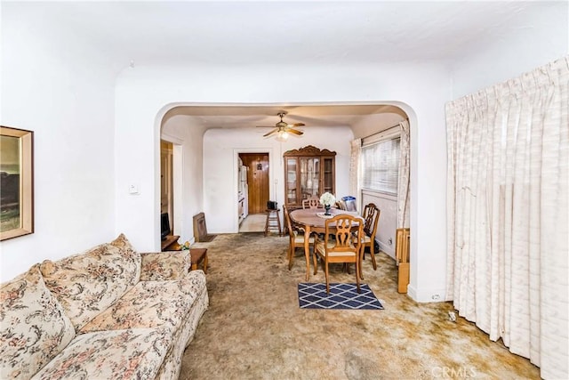 carpeted dining area featuring ceiling fan