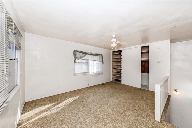 unfurnished bedroom with ceiling fan, a closet, and carpet