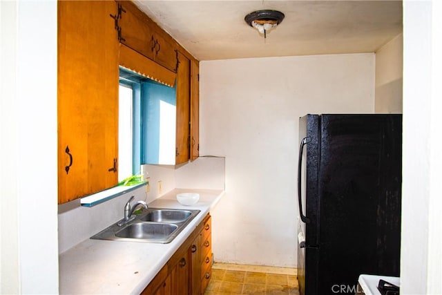 kitchen featuring sink and black fridge