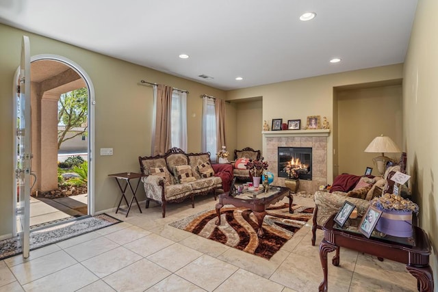 living room featuring light tile patterned floors and a tiled fireplace