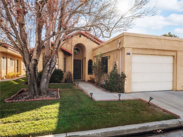 view of front of home with a garage and a front lawn