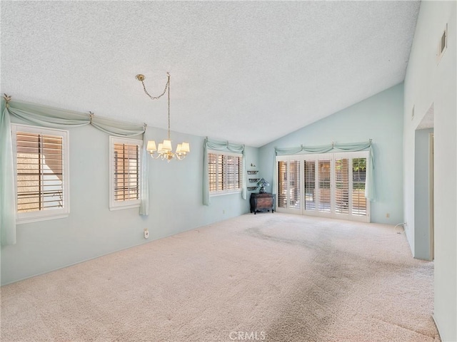 unfurnished living room with lofted ceiling and a healthy amount of sunlight