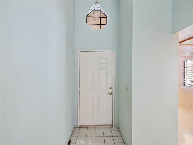 doorway to outside featuring light tile patterned flooring