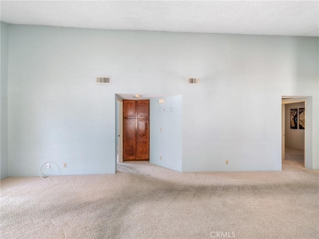 unfurnished room with light colored carpet