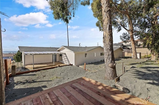 back of house with a wooden deck