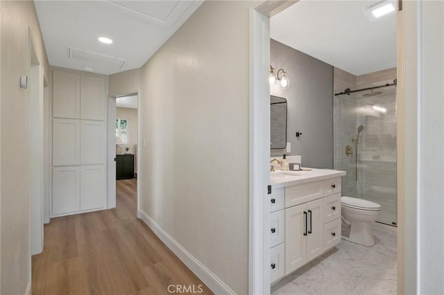 bathroom with vanity, toilet, wood-type flooring, and a shower with door