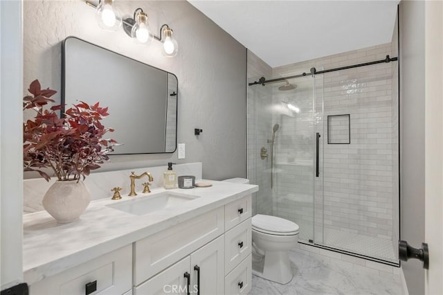 bathroom featuring vanity, toilet, and a shower with door