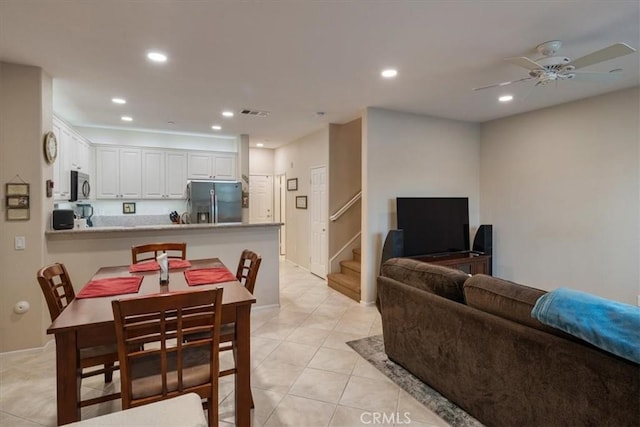 tiled dining space featuring ceiling fan