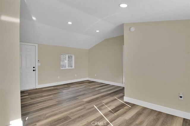 interior space with hardwood / wood-style floors and lofted ceiling