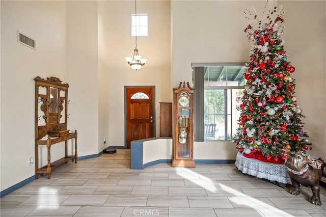 foyer entrance with a towering ceiling and an inviting chandelier