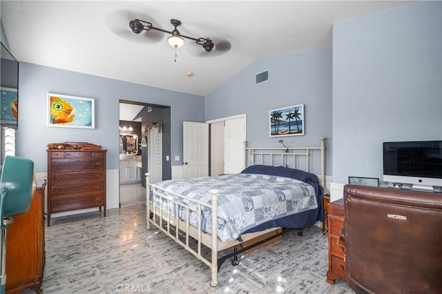 bedroom with a closet, vaulted ceiling, ceiling fan, and ensuite bathroom