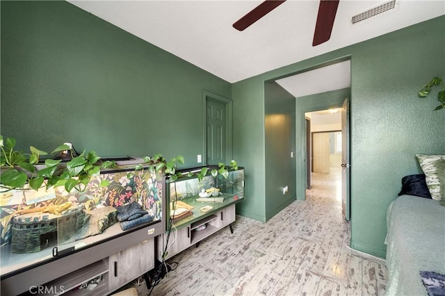 bathroom with ceiling fan and wood-type flooring