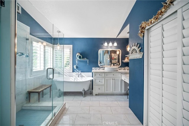 bathroom with vanity and separate shower and tub