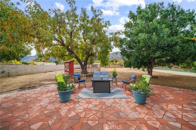 view of patio with a mountain view and an outdoor living space