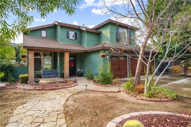 view of front of home featuring a porch and a garage