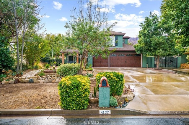 view of property hidden behind natural elements with a garage