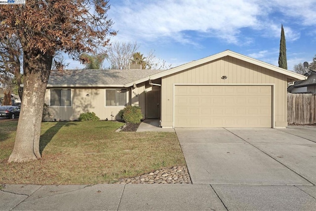 ranch-style house featuring a front yard and a garage