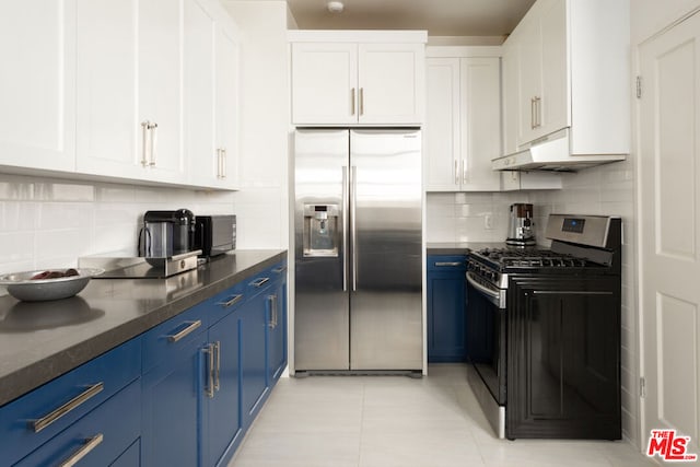 kitchen featuring white cabinetry, stainless steel appliances, blue cabinets, decorative backsplash, and light tile patterned floors