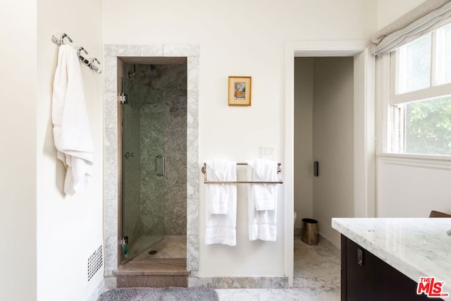 bathroom featuring vanity and an enclosed shower