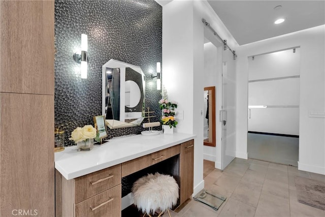 bathroom featuring tile patterned flooring, vanity, and backsplash