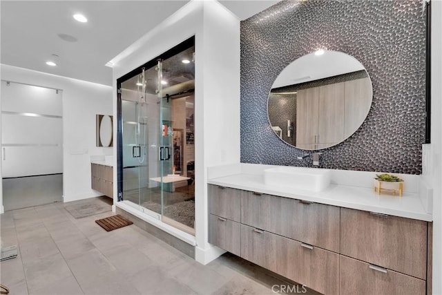 bathroom featuring walk in shower, vanity, tile patterned flooring, and tasteful backsplash