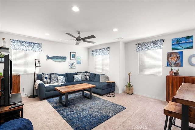 carpeted living room featuring ceiling fan