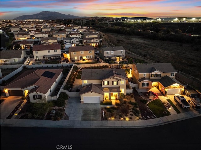 aerial view at dusk featuring a mountain view