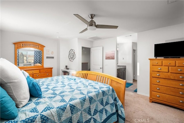 carpeted bedroom with connected bathroom and ceiling fan