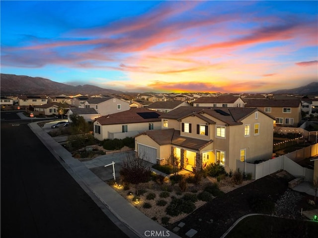 aerial view at dusk featuring a mountain view