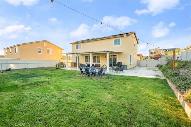 rear view of property with a yard, a pergola, and a patio