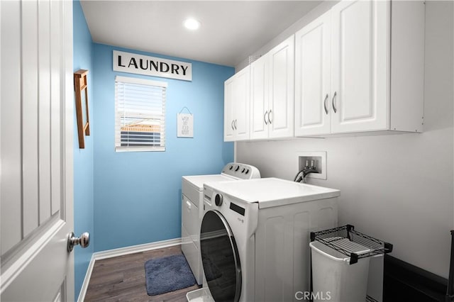 washroom with cabinets, dark hardwood / wood-style floors, and washing machine and dryer