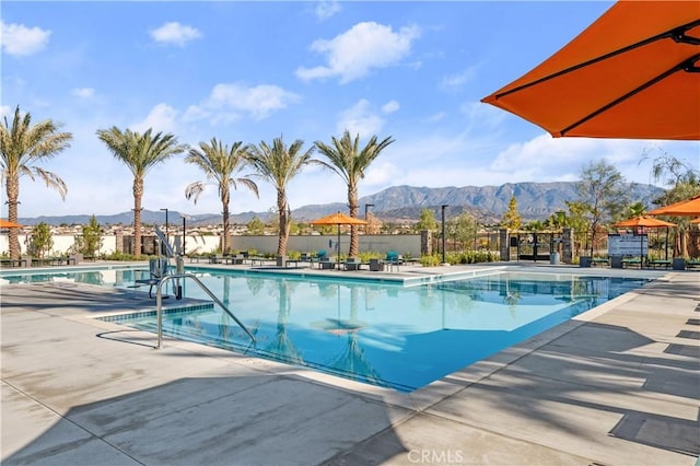 view of pool with a mountain view and a patio area