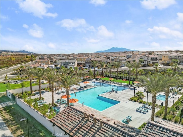 view of swimming pool featuring a mountain view and a patio area