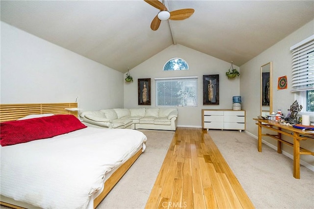 bedroom featuring hardwood / wood-style floors, ceiling fan, lofted ceiling, and multiple windows