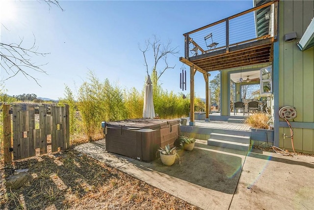 view of yard featuring a balcony and a hot tub