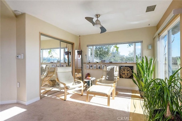 sunroom with visible vents, plenty of natural light, and a ceiling fan