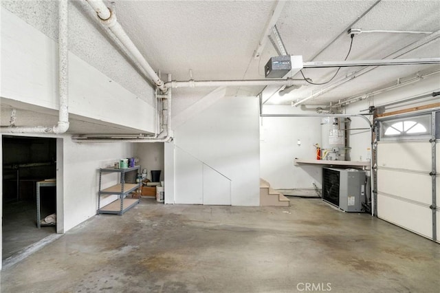 garage featuring a garage door opener and water heater