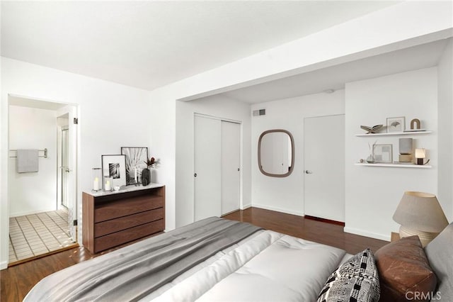 bedroom featuring a closet and dark wood-type flooring