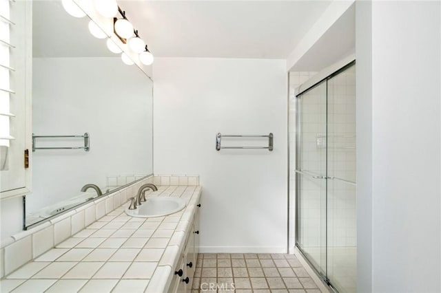 bathroom featuring tile patterned floors, vanity, and a shower with shower door