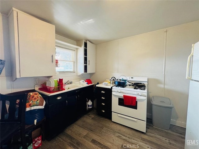 7805 Panama Rd, Lamont, CA 93241 - kitchen featuring white cabinets, sink, white appliances, and dark wood-type flooring