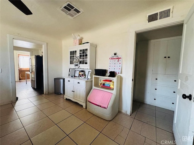 7805 Panama Rd, Lamont, CA 93241 - interior space featuring stainless steel fridge, ceiling fan, and light tile patterned flooring
