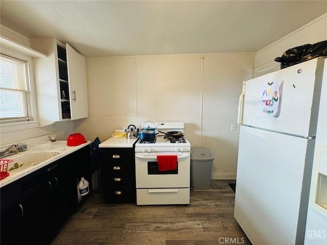 7805 Panama Rd, Lamont, CA 93241 - kitchen with white cabinetry, dark hardwood / wood-style flooring, white appliances, and sink