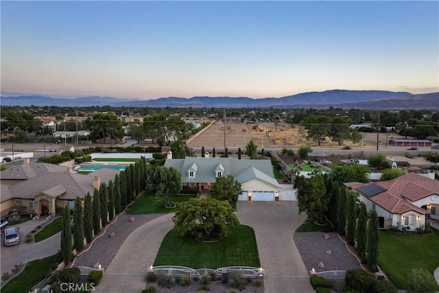 aerial view at dusk featuring a mountain view