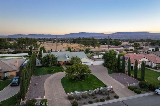 aerial view at dusk featuring a mountain view