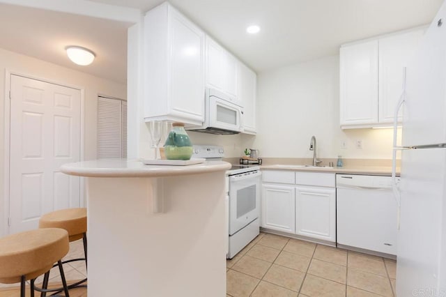 kitchen with white cabinetry, light tile patterned flooring, white appliances, and kitchen peninsula