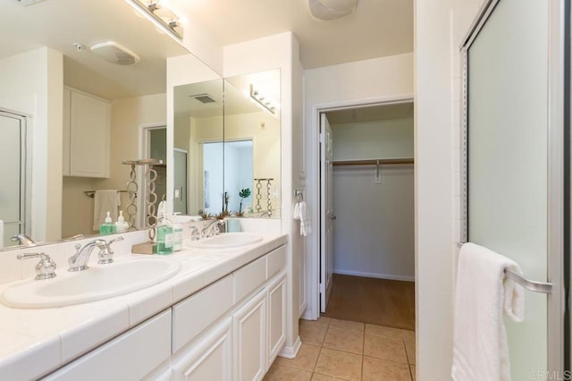 bathroom featuring vanity, tile patterned floors, and a shower with shower door